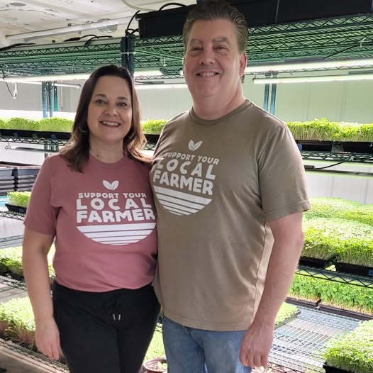 woman and male microgreen farmers in their growing facility in Liberty MO