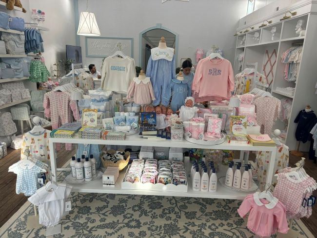 Baby clothing and gifts in a pastel colored boutique