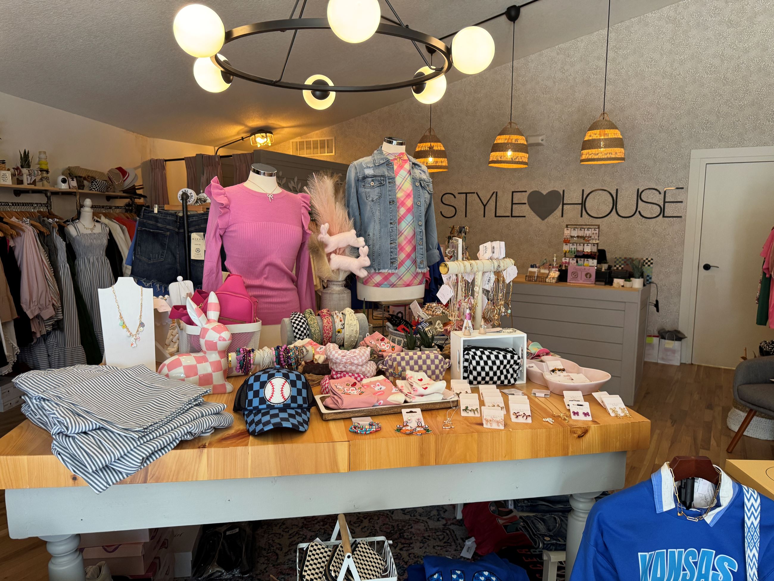 Display of women's clothing and accessories in pinks and blacks